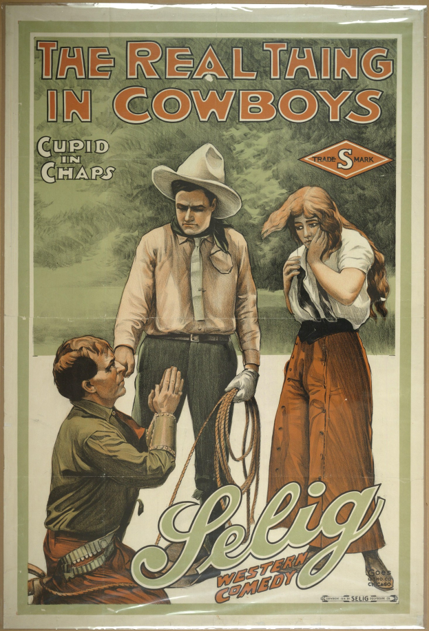 Poster an einer Wand mit drei Personen in Cowboy-Kleidung und dem Text "The Real Thing in Cowboys" darüber auf einem hellgelben Hintergrund.