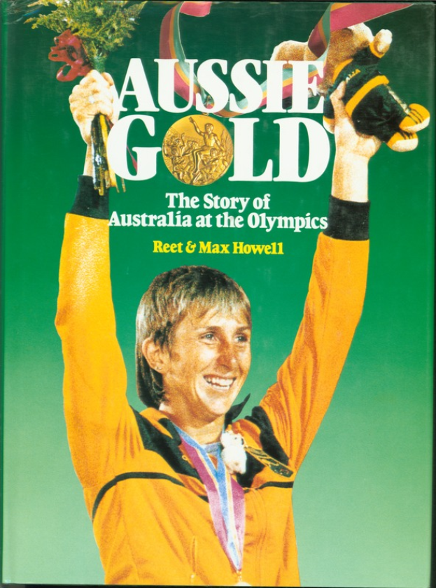 Ein Buch mit dem Titel "Aussie Gold: The Story of Australia at the Olympics", das eine Person mit einem Blumenstrauß und einer Goldmedaille um den Hals zeigt.